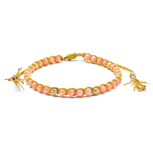 pink coral healing gem bracelet with gold dipped stardust beads and tassel