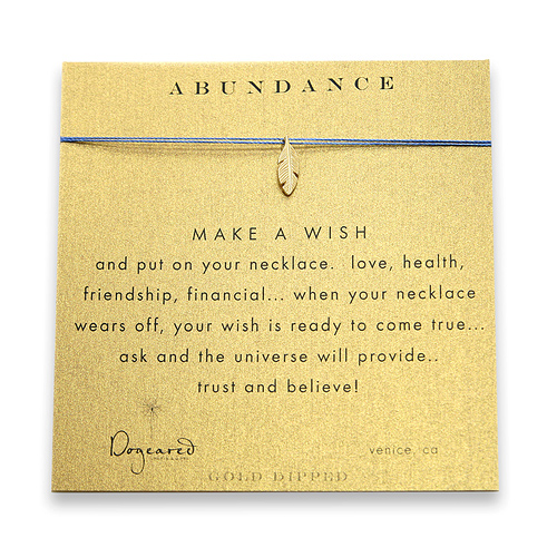 abundance make a wish necklace with gold dipped feather on ocean