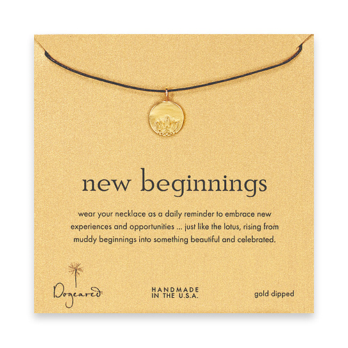 gold dipped new beginnings necklace on chocolate waxed cotton