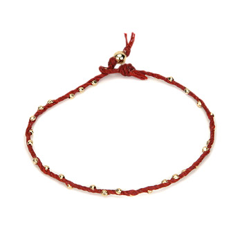 sparkle twisted strand gold dipped bracelet on red irish linen