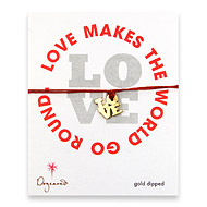 gold dipped love charm bracelet on burnt orange irish linen