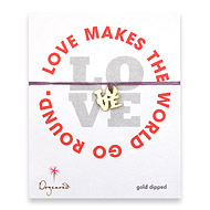 gold dipped love charm bracelet on lilac irish linen