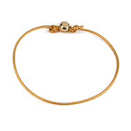 gold dipped peace bead bracelet on honey leather cord