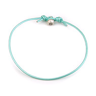 oxidized peace bead bracelet on aqua leather cord