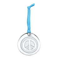 recycled glass peace ornament on light blue leather