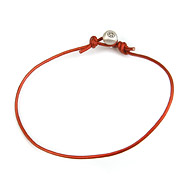 oxidized peace bead bracelet on fire leather cord