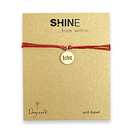 shine love gold dipped bracelet on red irish linen