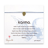 karma make a wish necklace with gold dipped skull on ocean
