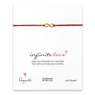 small infinite love bracelet on red irish linen, gold dipped