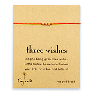 three wishes rose gold dipped stardust bead bracelet on burnt orange irish linen