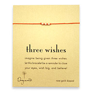 three wishes rose gold dipped stardust bead bracelet on burnt orange irish linen